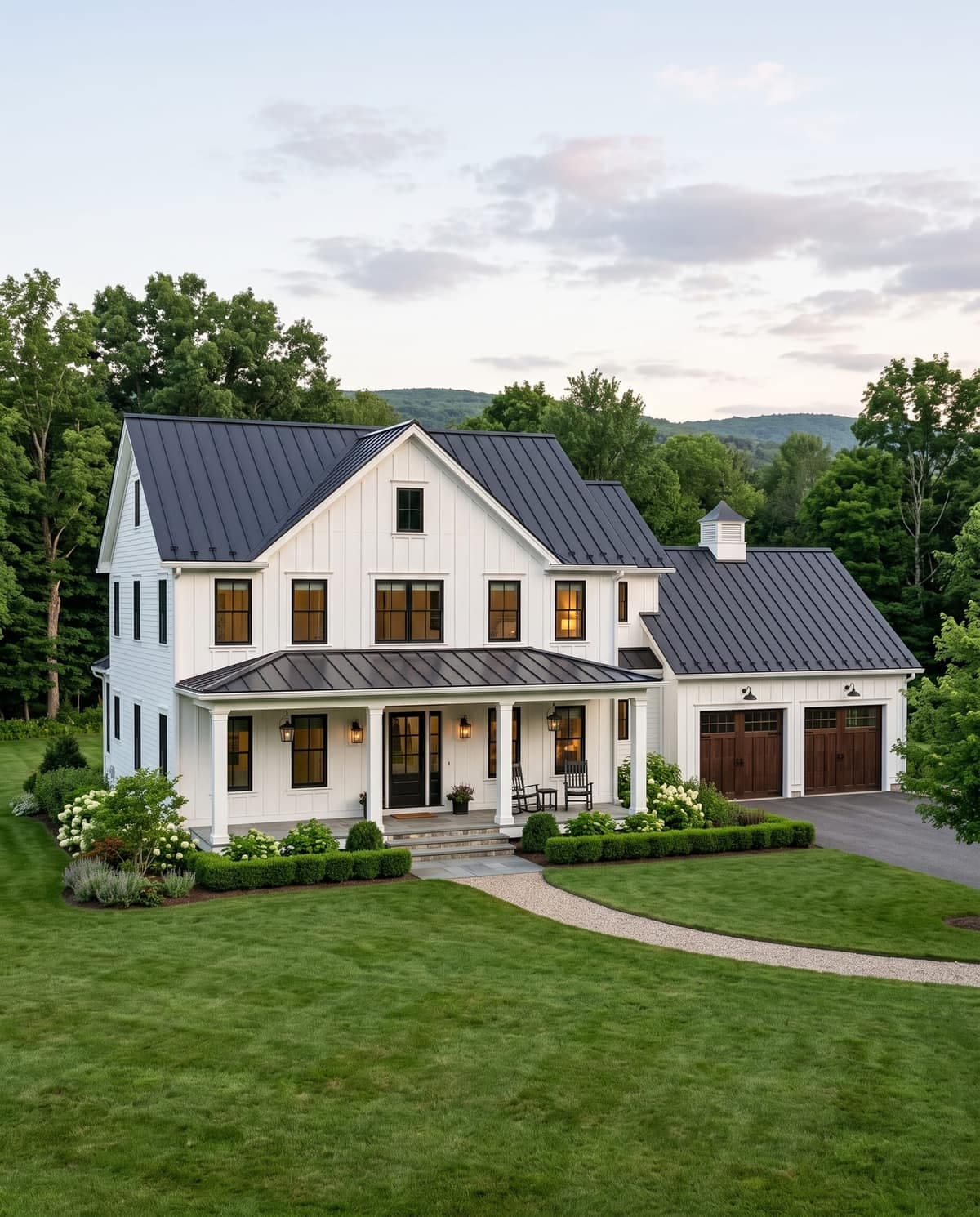 A freshly painted white farmhouse with a covered front porch